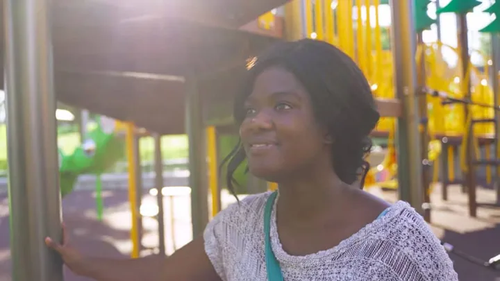 A woman at a playground, from the CAP STJOE video by Marks Media